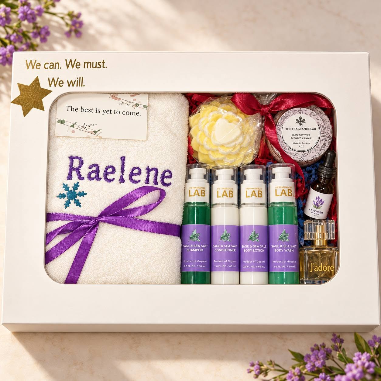 Personalised gift box with an embroidered towel, perfume, bath products, a candle and purple ribbon
